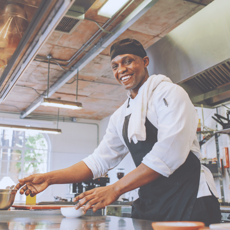 Happy professional chef in UK commercial kitchen - Oil Collector partner
