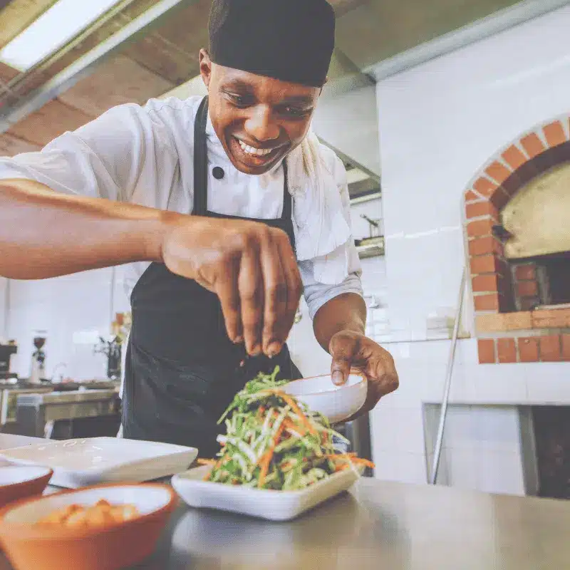 Professional chef preparing food in modern kitchen - contact Oil Collector